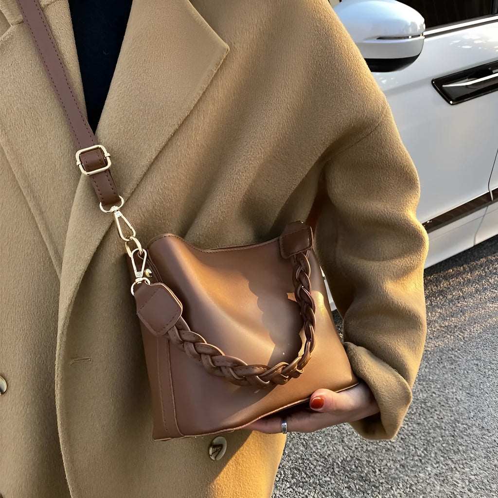 Retro unisex brown PU bucket bag with woven detail, shown with crossbody strap.
