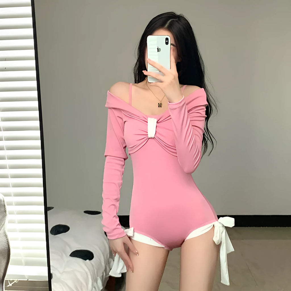 Women's long sleeve one-piece swimsuit in black or pink with polyester fibre construction