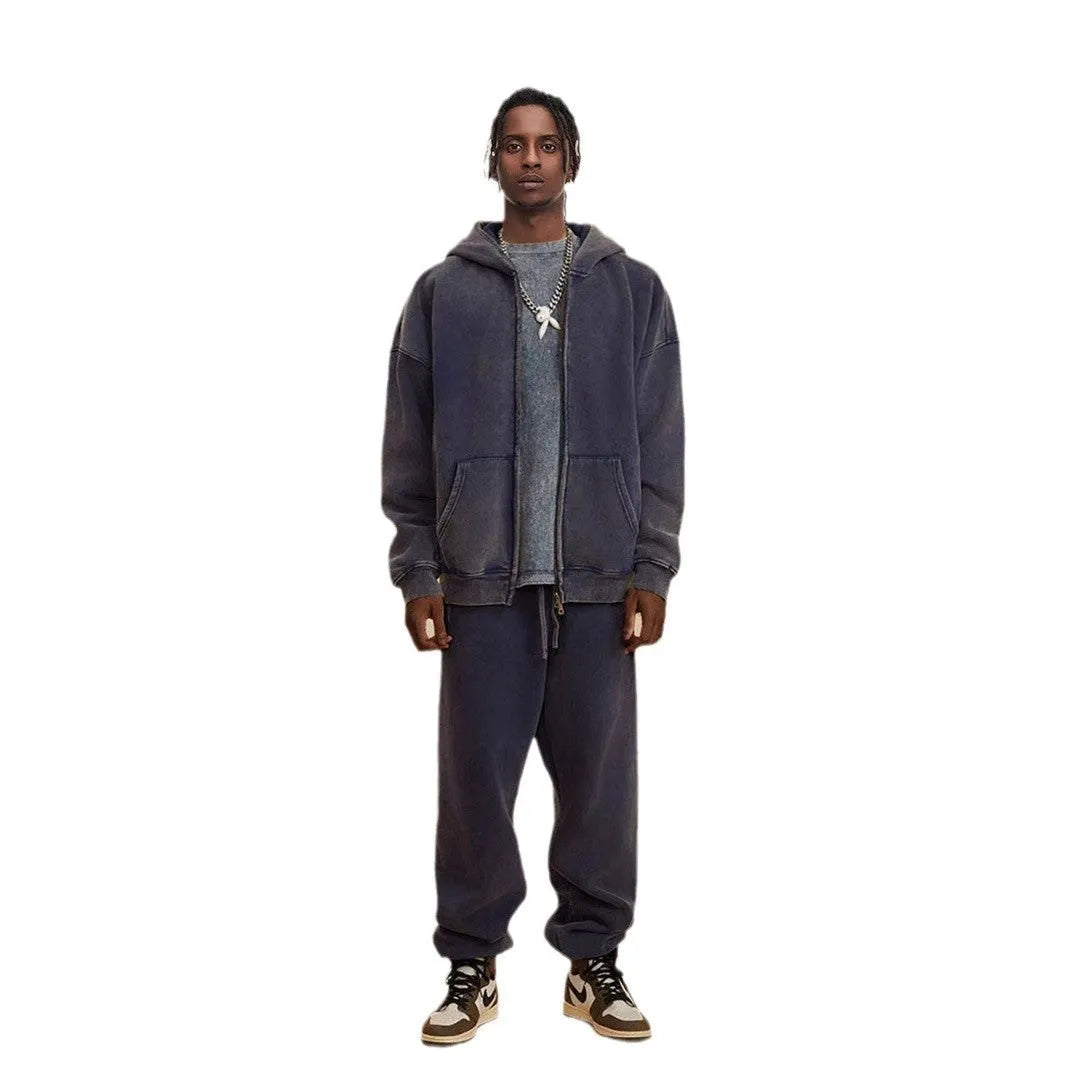Man wearing a washed black fleece-lined hooded cardigan with a double zipper