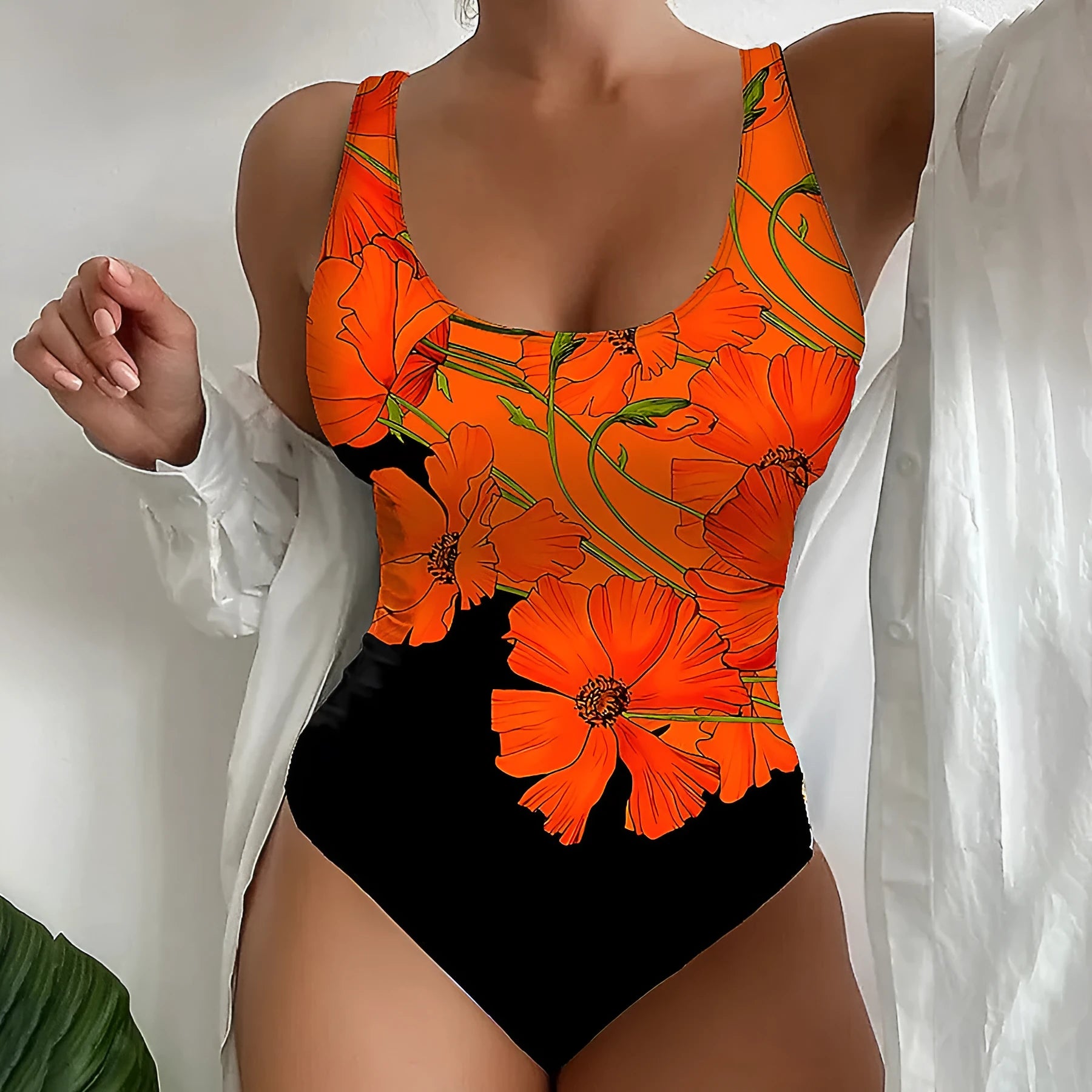 Orange floral print slim fit backless one-piece swimsuit on a mannequin.