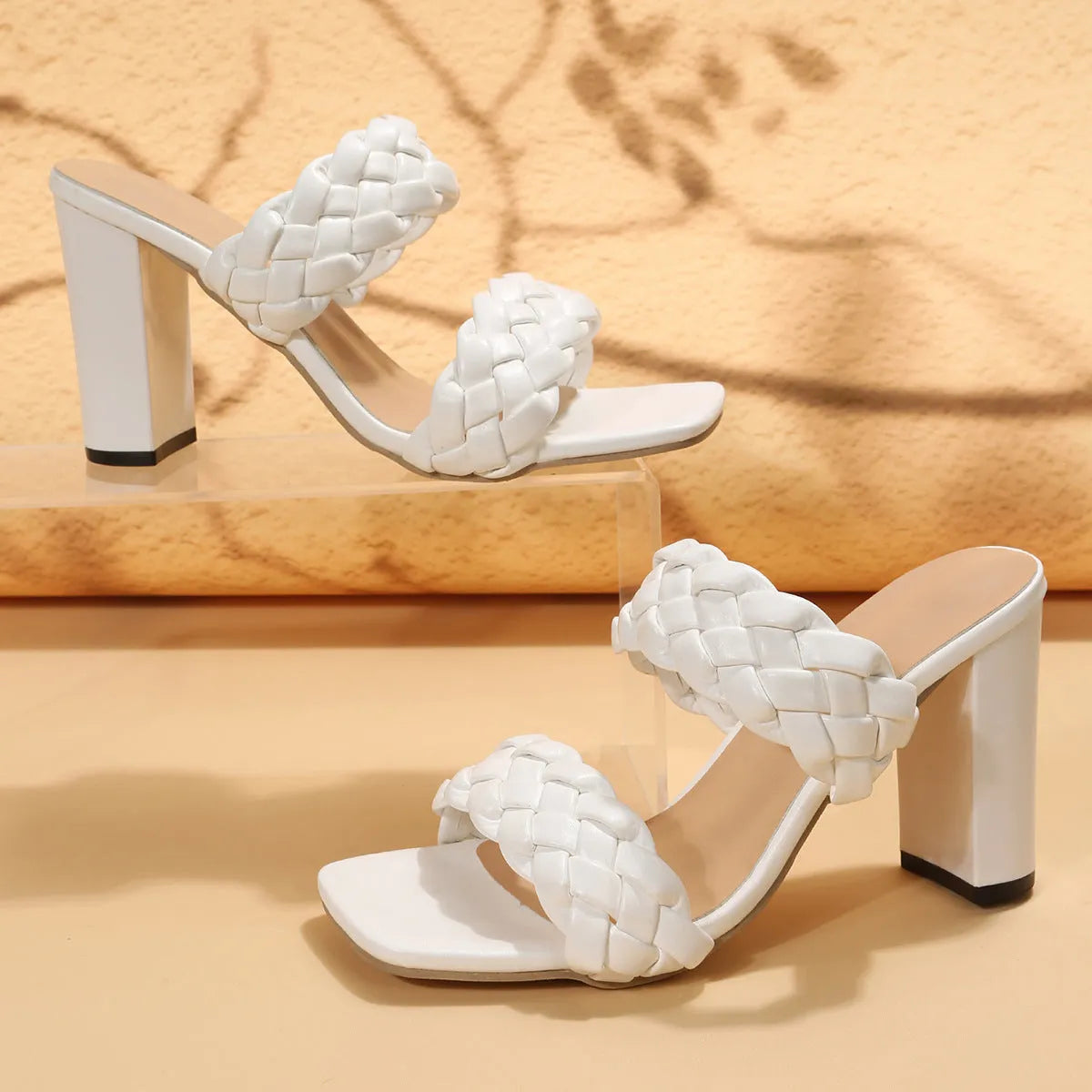 Square toe flip-flops with chunky heel and woven twisted straps in white and apricot colours.