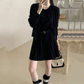 Women's black knitted two-piece set with long-sleeve cardigan, pleated vest skirt, 3D pattern, and a belt.