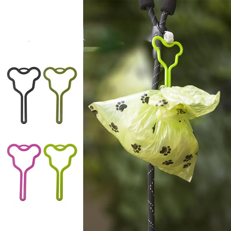 Dog poop bag holder with fixed clip and adjustable Velcro fastener on a leash.