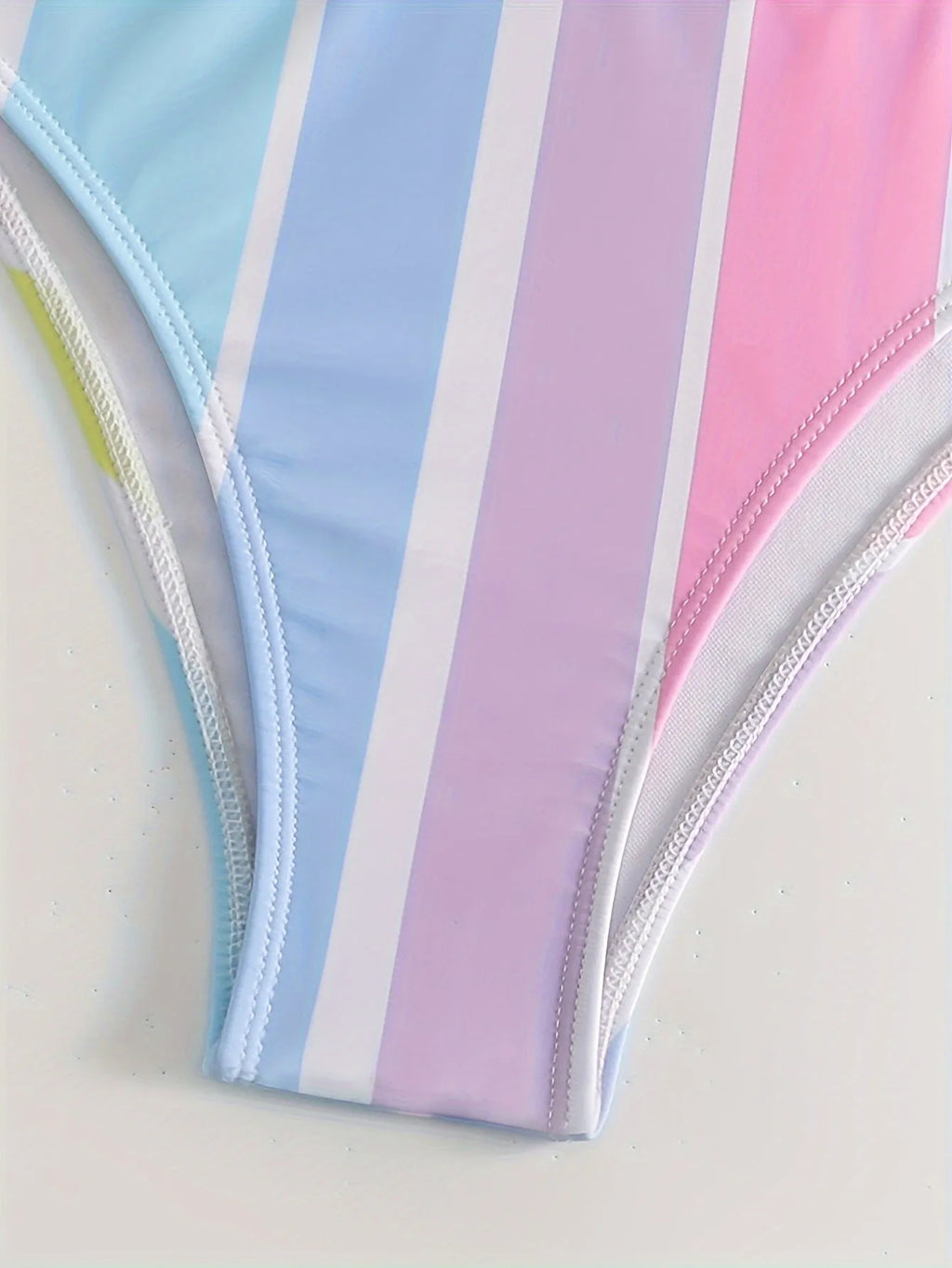 Women's striped sports bikini top and briefs set on a white background