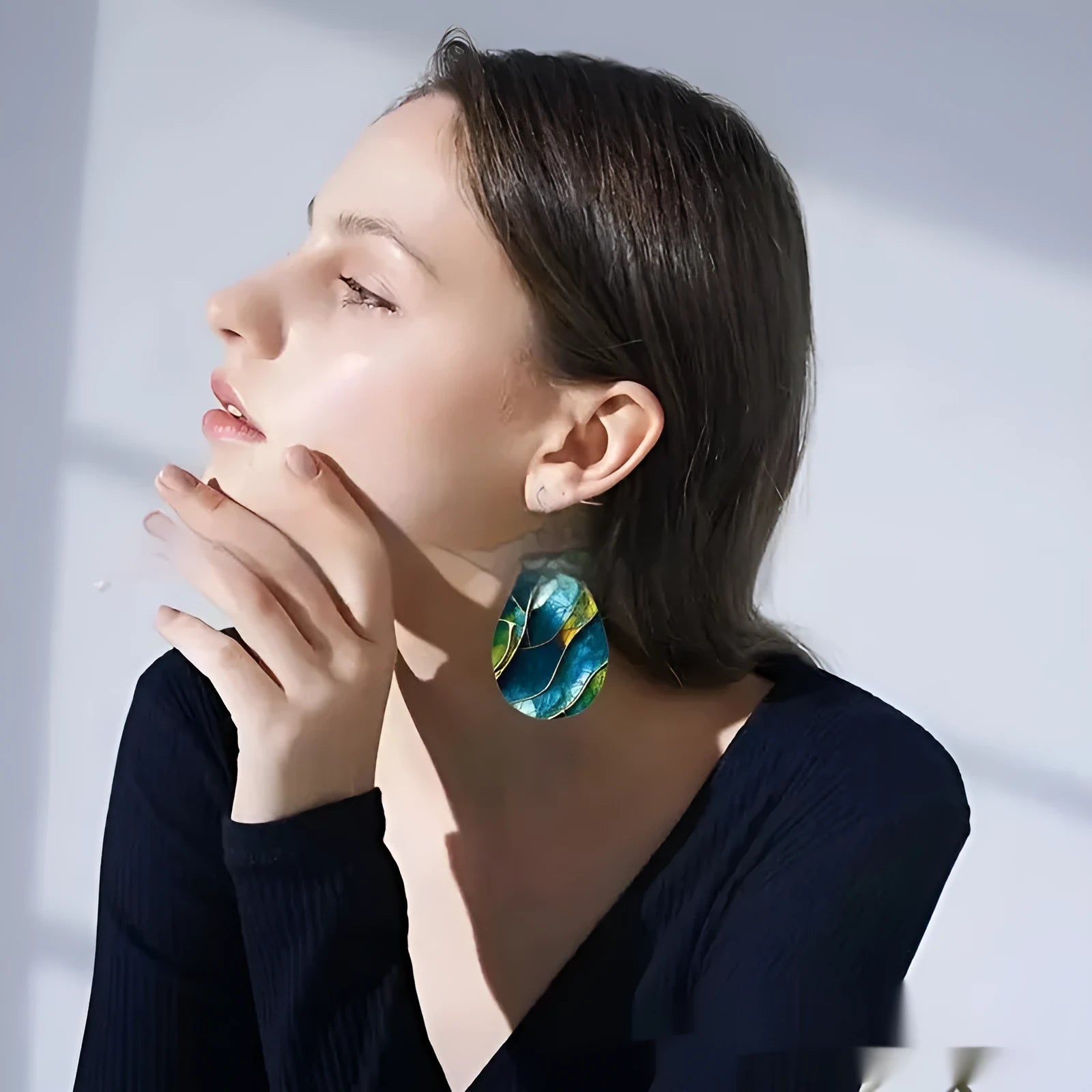 A pair of drop-shaped acrylic earrings featuring a printed flat branch knot design.