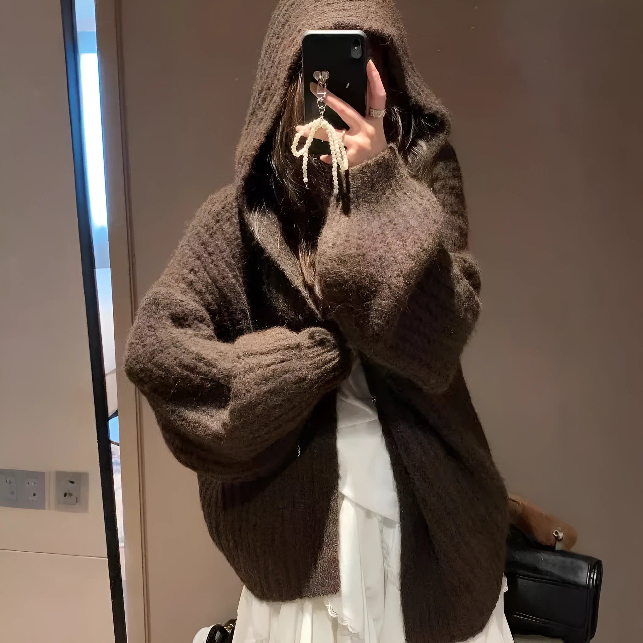 Brown loose-fit hooded cardigan sweater for women on a hanger