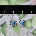 Handmade Miao ethnic silver earrings with turquoise geometric flower disc design