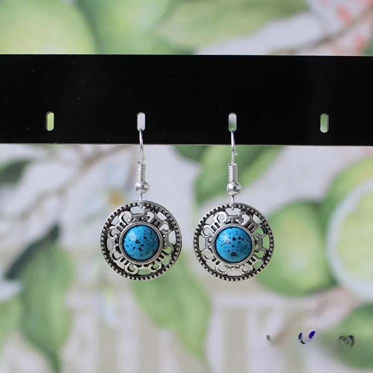 Handmade Miao ethnic silver earrings with turquoise geometric flower disc design