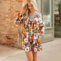 Orange floral print V-neck mini dress with long lace sleeves on a mannequin.