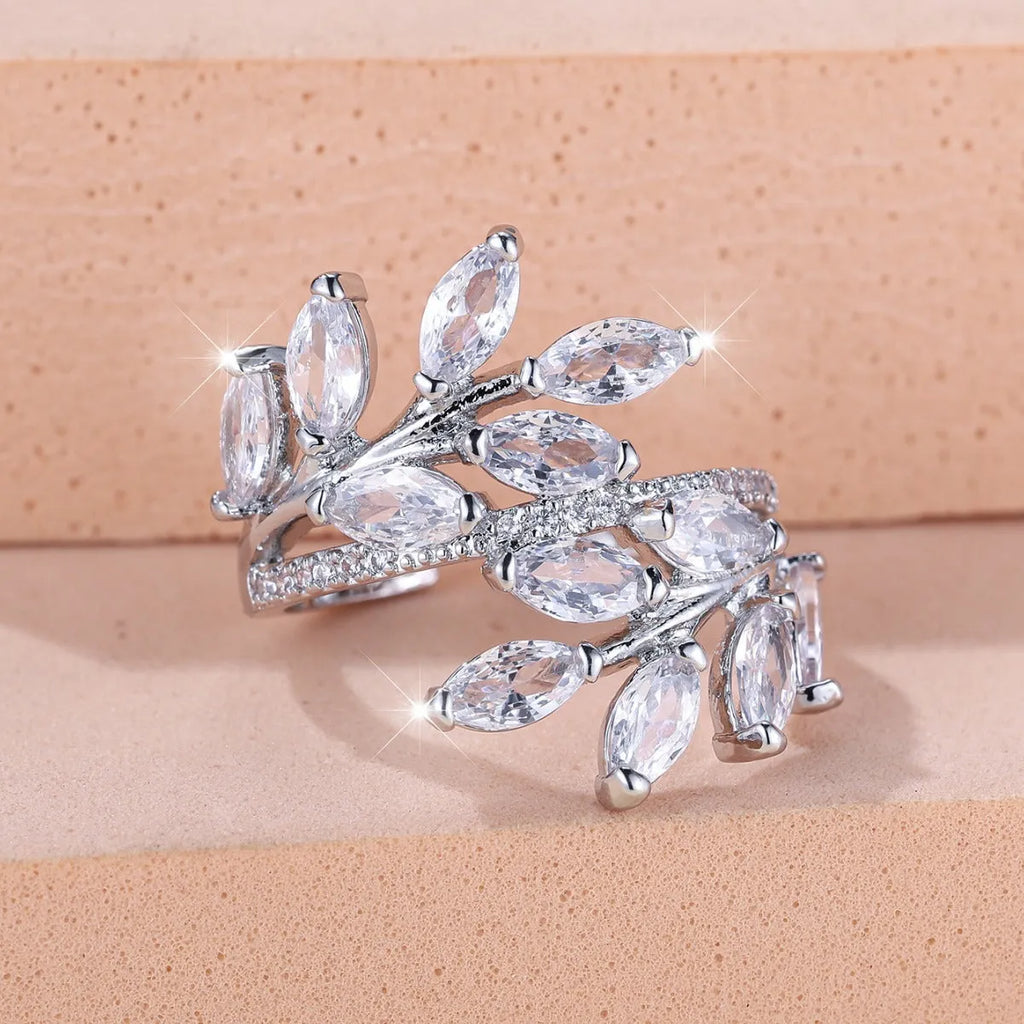 Adjustable copper leaf ring in platinum or rose gold finish on a white background