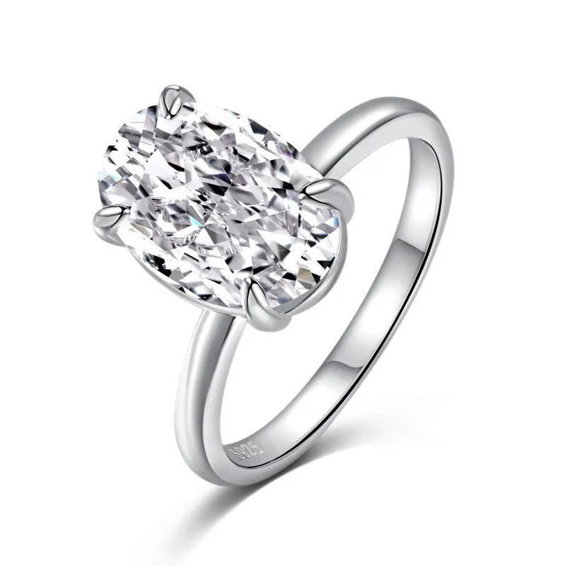 Oval ring with four-claw setting showing hand-cut gemstone in gold and silver colour options