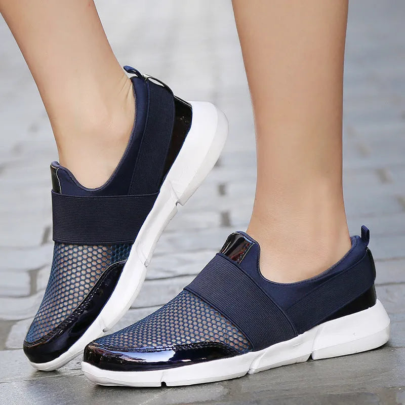 Women's low-top casual sneaker in grey with breathable mesh upper and lightweight sole.
