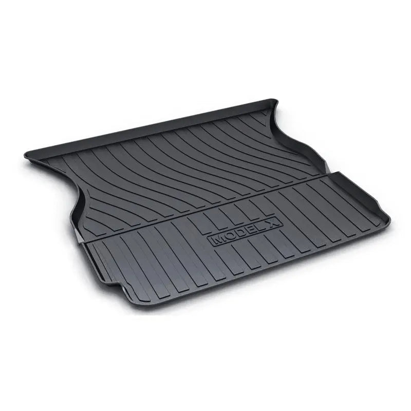 Black rubber floor mat for Tesla car interior with textured TPE footrest section.