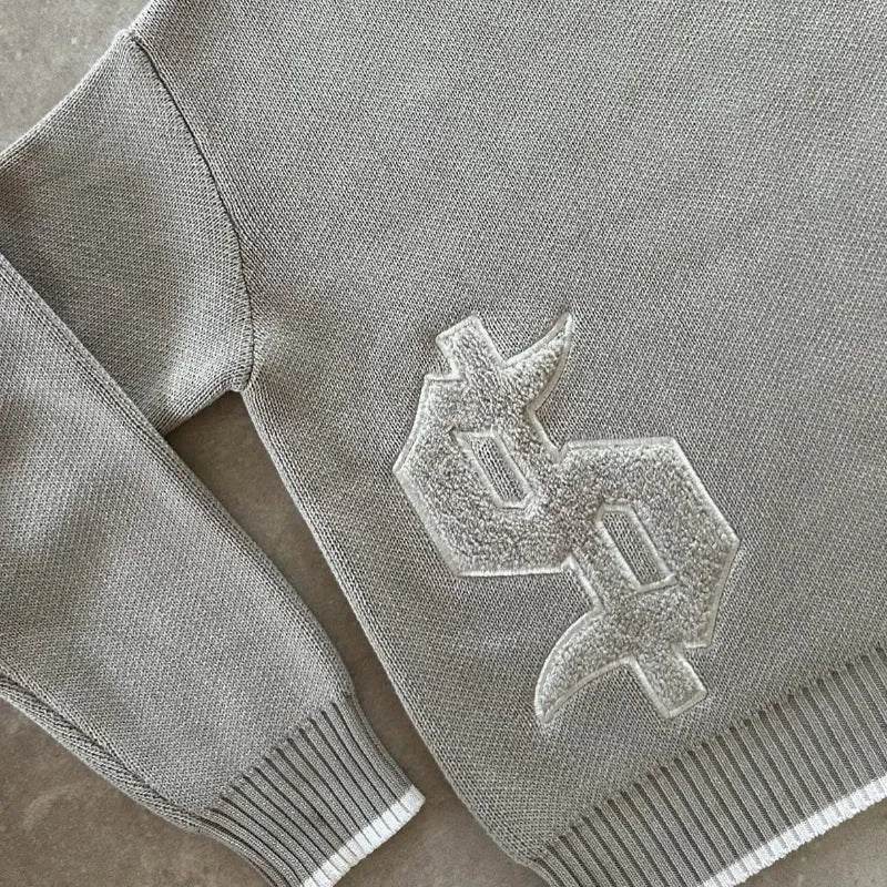 Grey loose-fitting acetate knitwear coat with jacquard pattern and long sleeves.