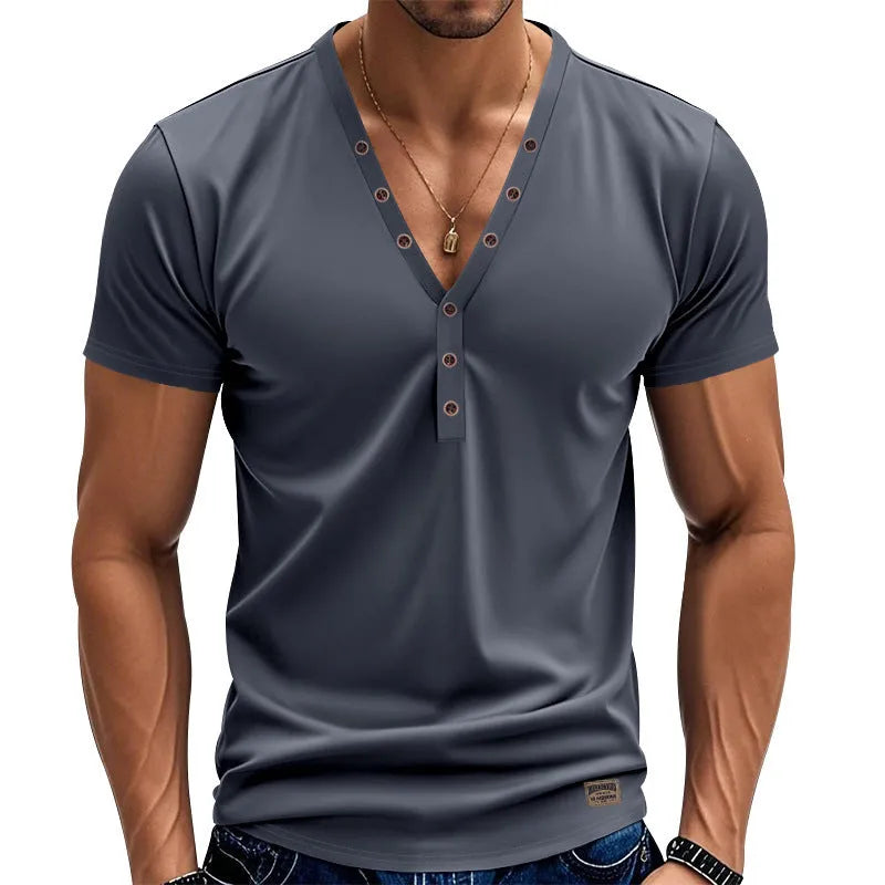 Man wearing a loose fit solid colour V-neck pullover top with a small button design detail.