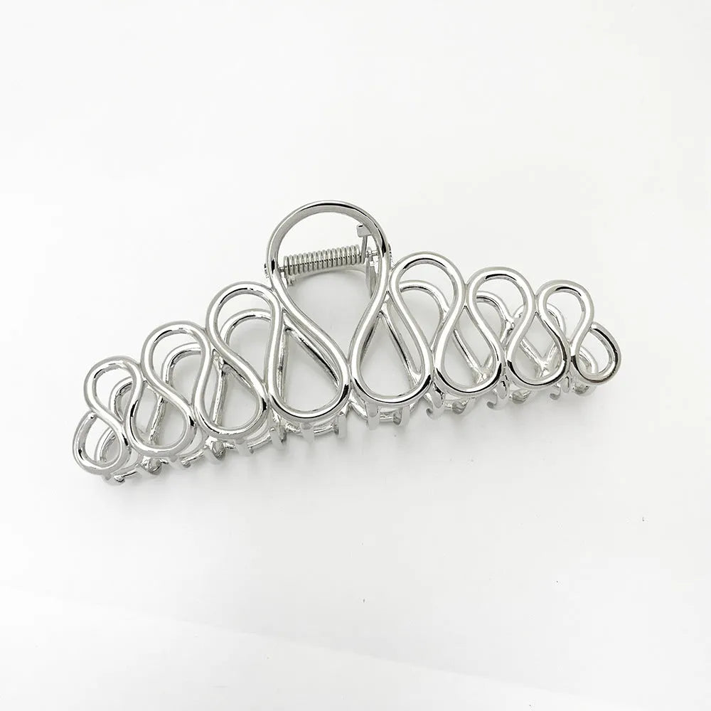 Minimalist large hair clip with electroplated alloy construction and tassel accents in gold or silver colour