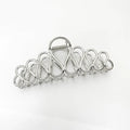 Minimalist large hair clip with electroplated alloy construction and tassel accents in gold or silver colour