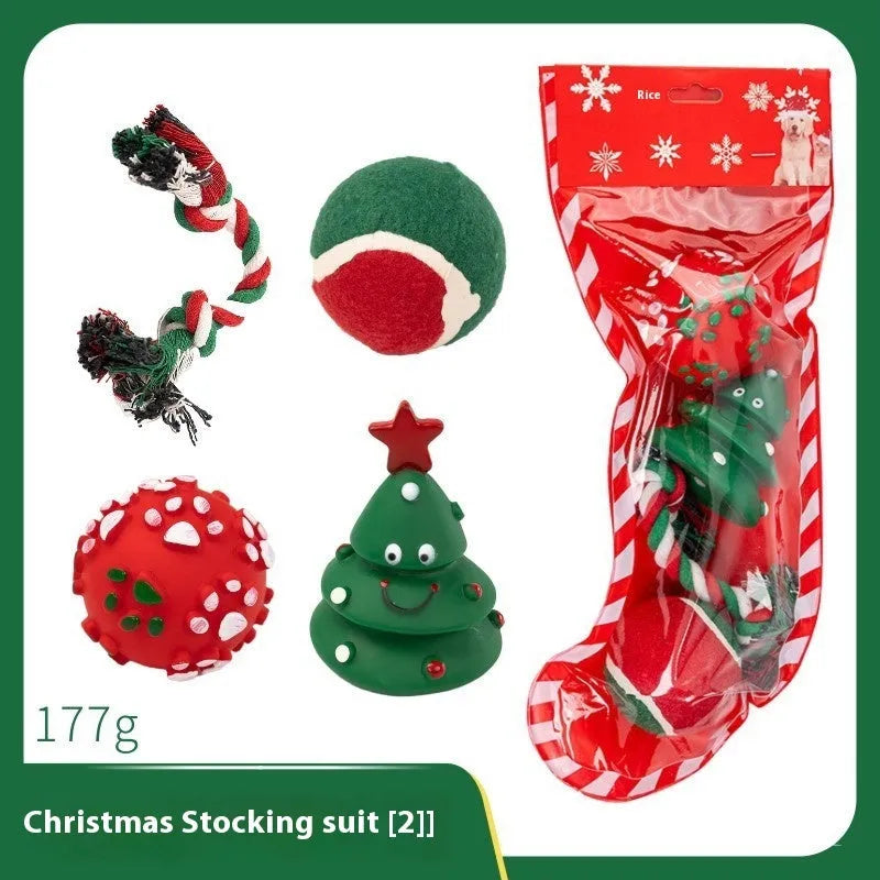 Set of vinyl Christmas-themed dog chew toys including balls, ropes, and Santa shapes in a gift bag.