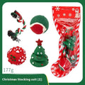 Set of vinyl Christmas-themed dog chew toys including balls, ropes, and Santa shapes in a gift bag.