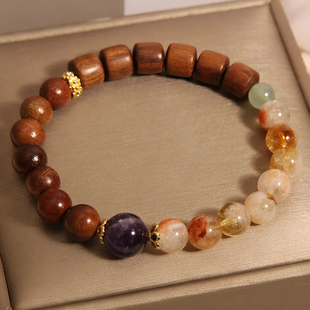 Yellow tower crystal, ebony, and amethyst bead bracelet with pearl and rhinestone details.