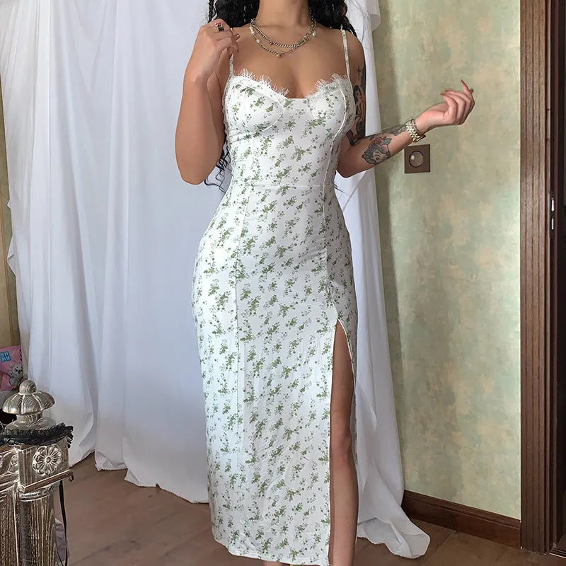 Women's long dress with lace flowers print, thigh-high slit, and suspender straps in blue.
