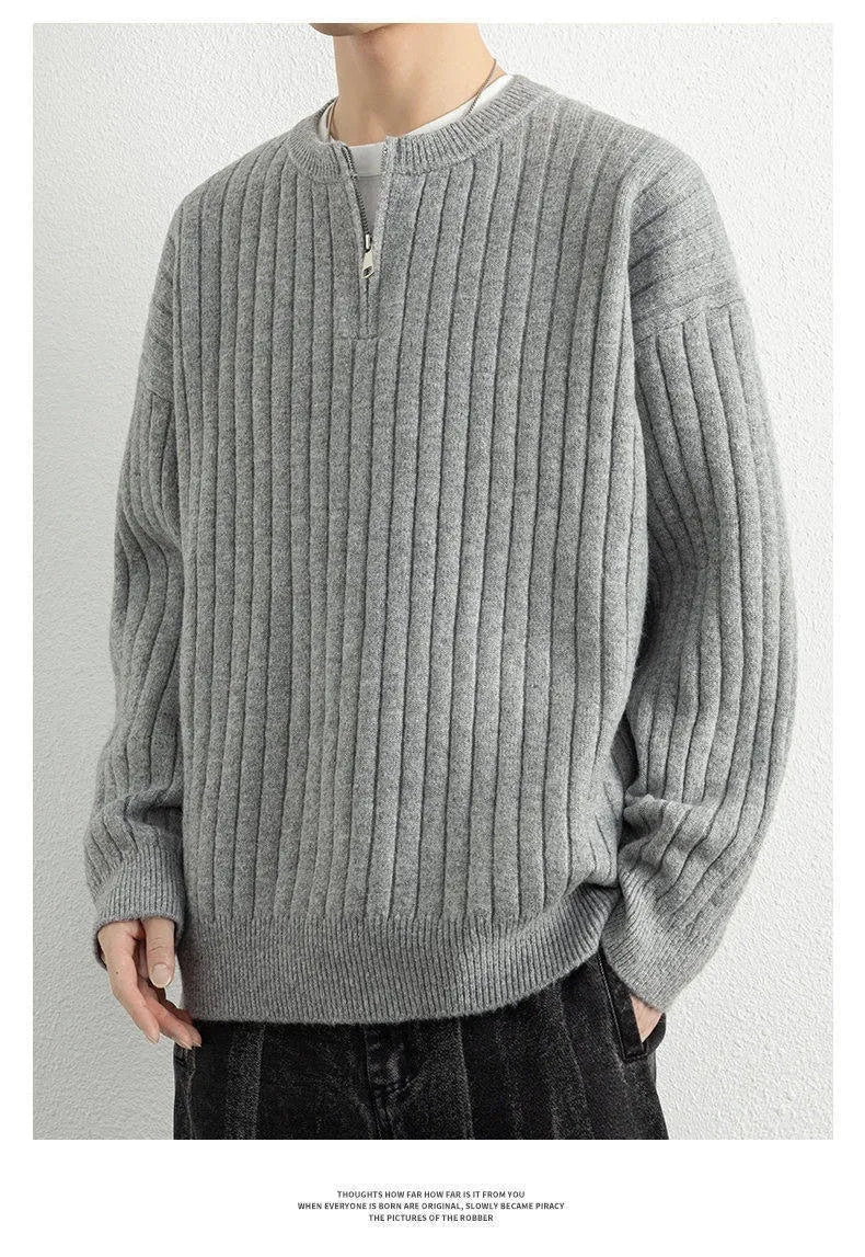 Men's grey half-zip textured knit sweater showing loose fit and long sleeve design
