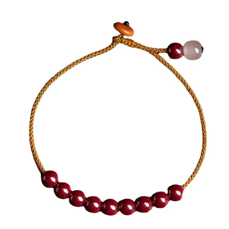 Hand-woven cinnabar and Hetian jade bracelet with geometric design showing natural colour variation
