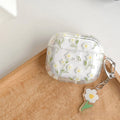 Transparent white floral patterned soft TPU protective case for Apple AirPods on a table.