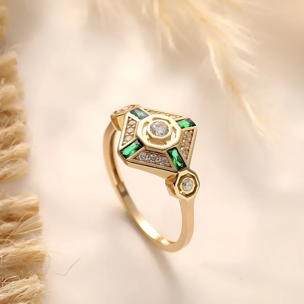 Square geometric women's ring with a lvzuan colour gemstone centrepiece on a plain background.