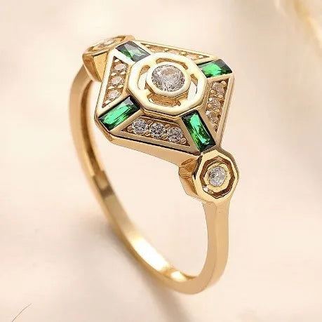Square geometric women's ring with a lvzuan colour gemstone centrepiece on a plain background.