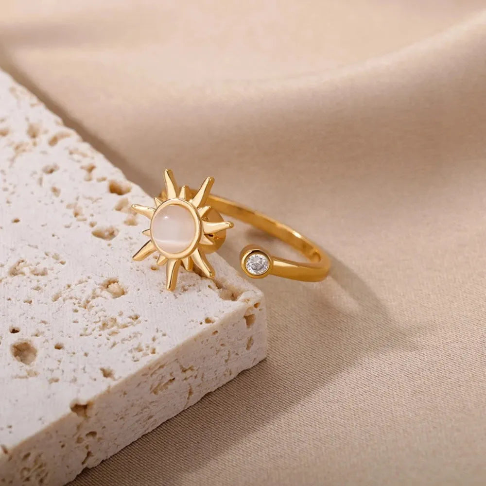 Gold and platinum adjustable open-mouth decompression ring with rotatable geometric component.