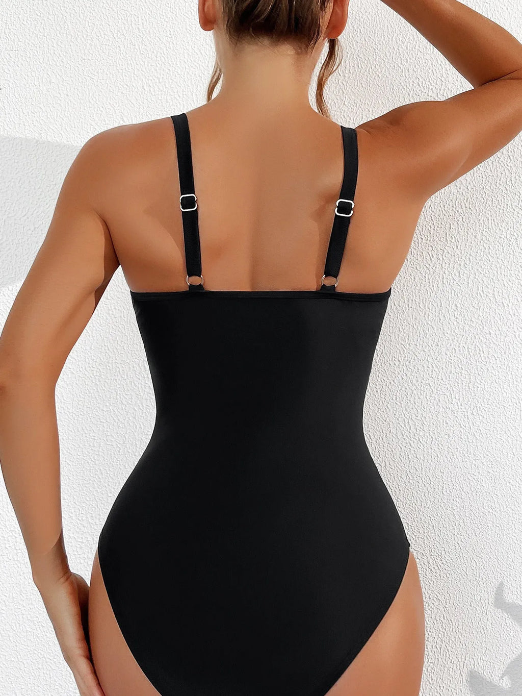 Black women's halter neck one-piece swimsuit with mesh panels on mannequin
