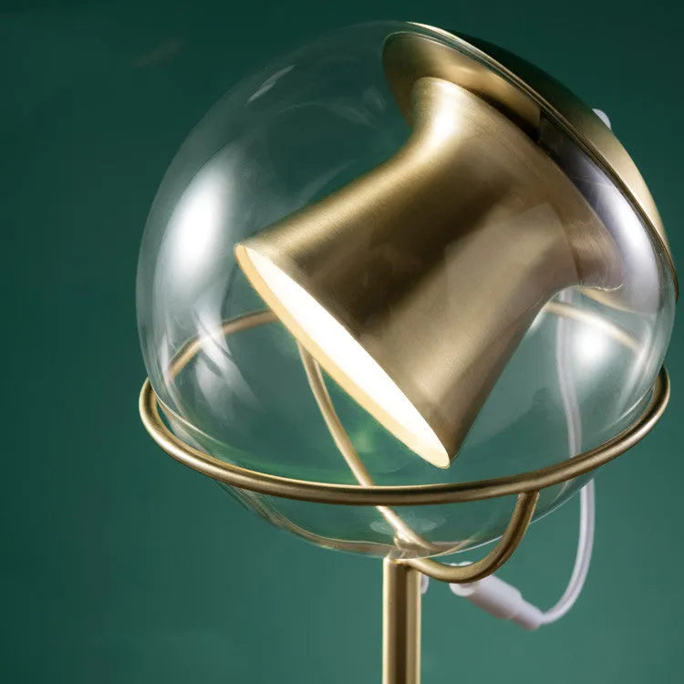 Modern desk lamp with a glass lampshade and touch-sensitive base for dimming control.