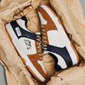 Lace-up casual sneakers in rainbow white blue colour on a plain background, showing wear-resistant sole and simple design