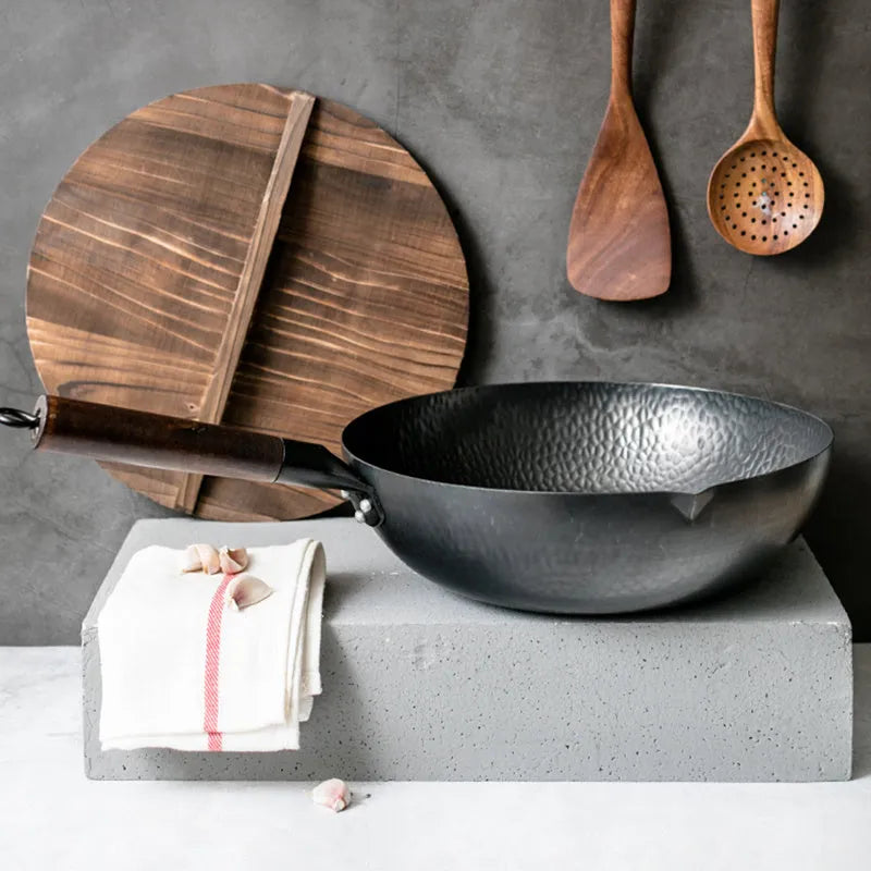 Traditional black iron wok pan with wooden handle measuring 32cm diameter
