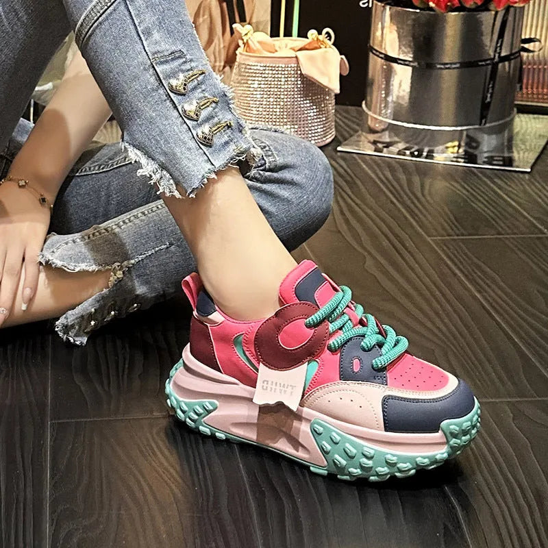 Women's leather sports casual shoes with thick sole and lace-up front in black and white colour.