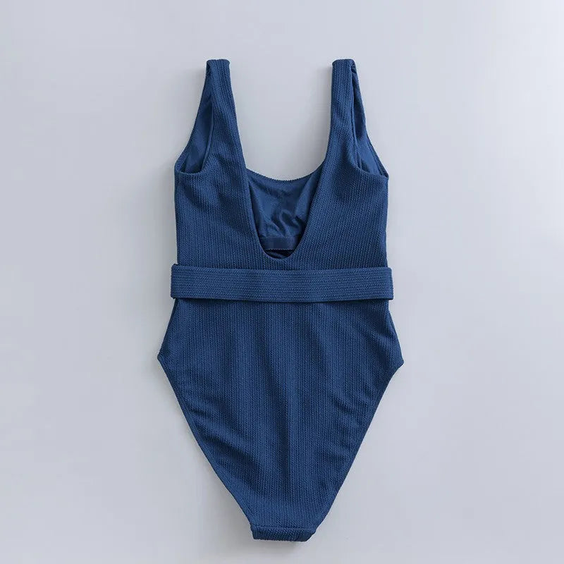 Navy blue one-piece women's swimsuit with triangle design and chest pads on a mannequin