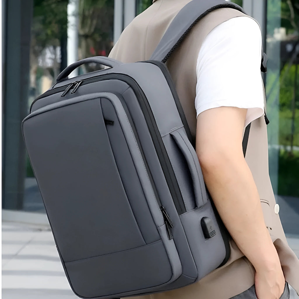 Large black waterproof backpack with curved shoulder straps showing business travel design