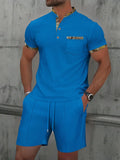 Men's grey zip-up polo collar short sleeve suit with matching shorts laid flat