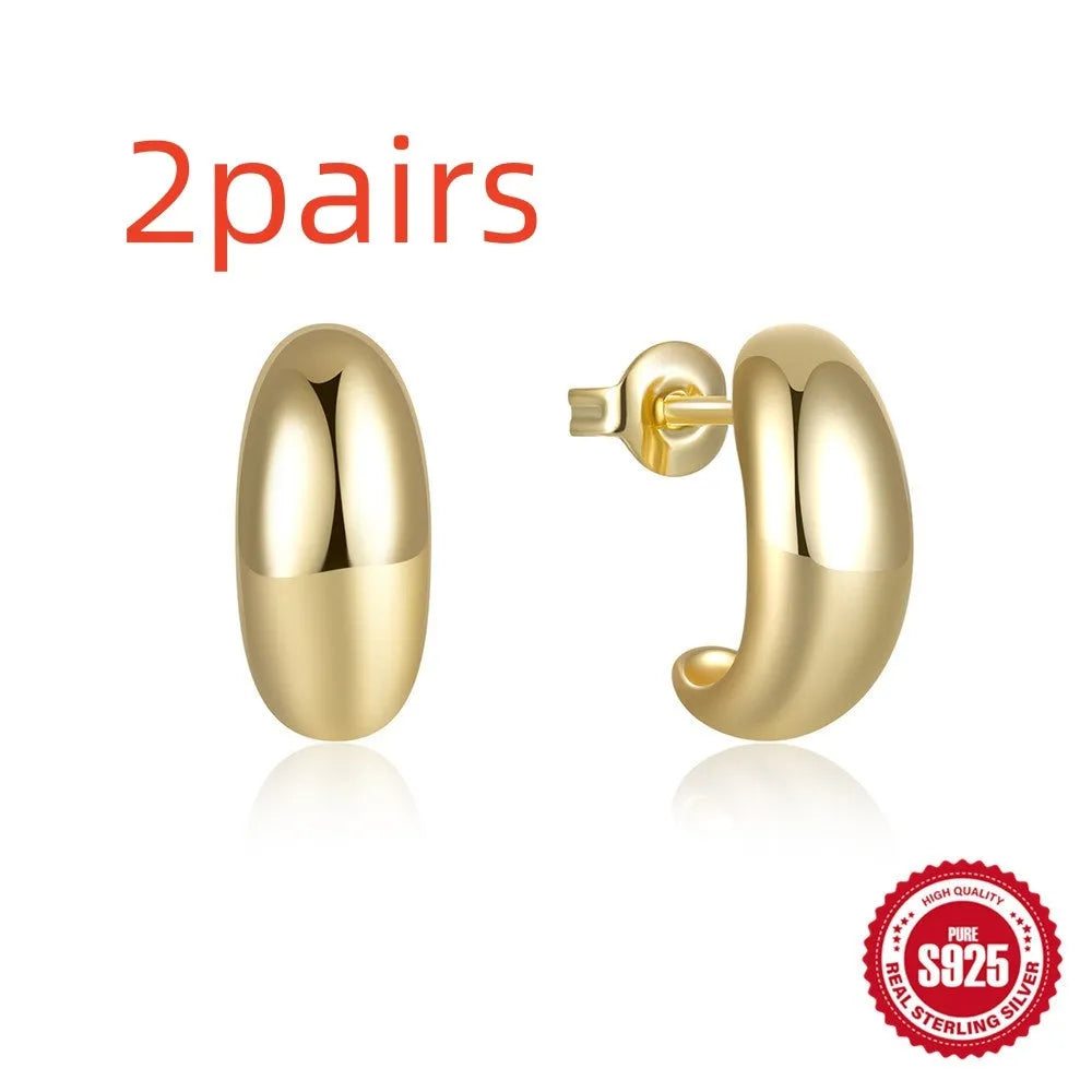A pair of simple C-shaped ring stud earrings in 925 sterling silver, shown in both gold and silver colour options.