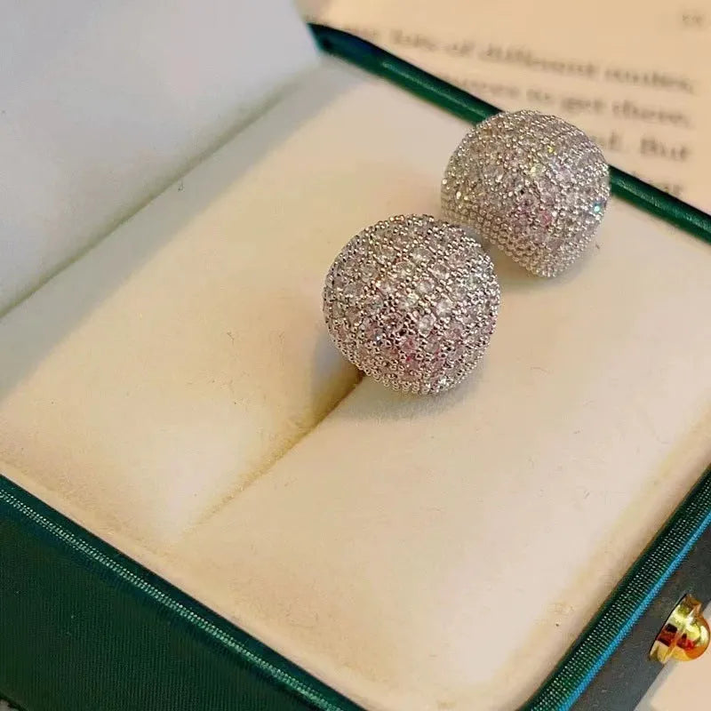 Gold and white geometric drop earrings with flashing lights and spherical elements