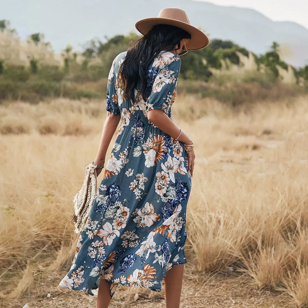 Women's floral print beach dress with V-neck, short sleeves, elastic waist, and mid-length skirt.