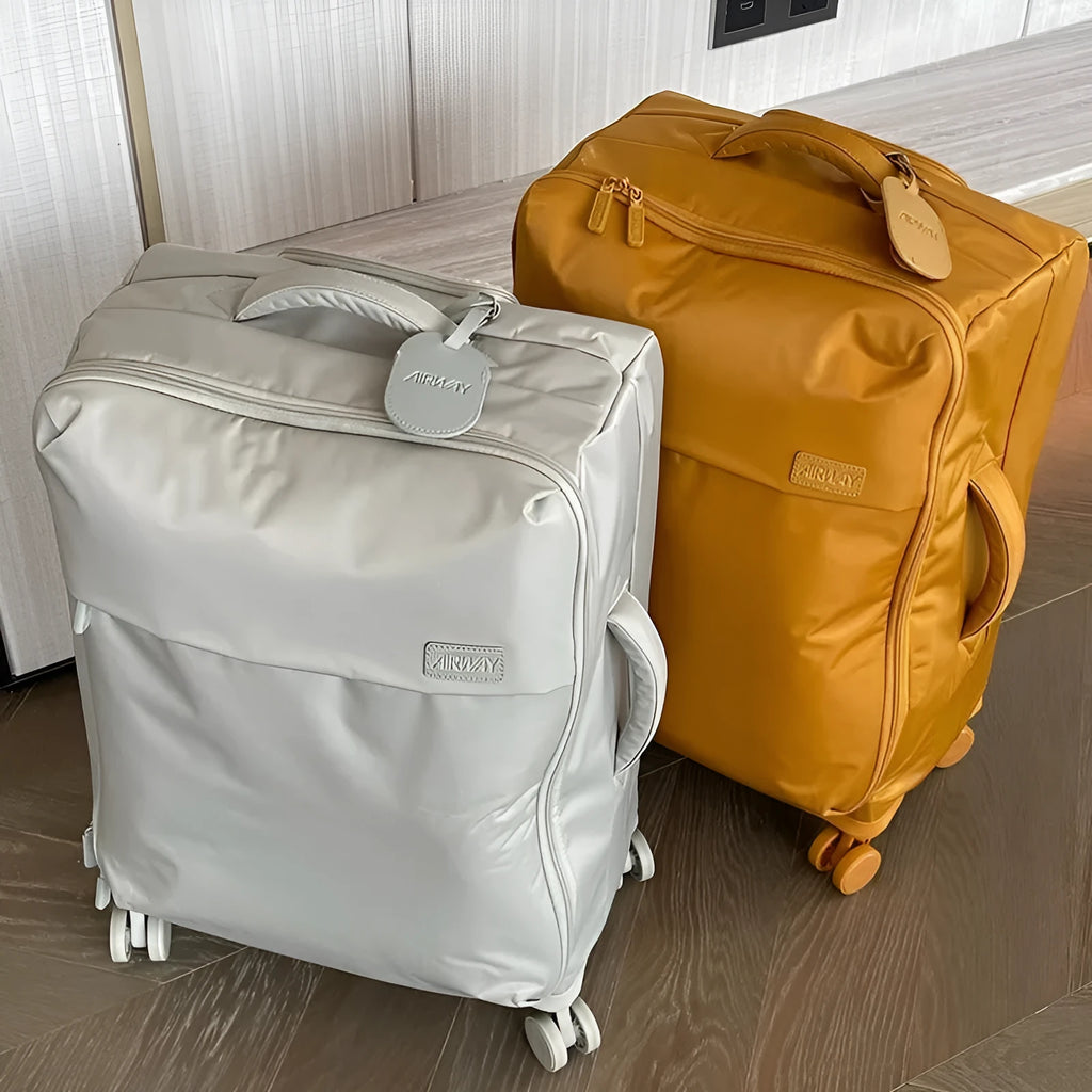 Ultra-light waterproof Oxford cloth suitcase in bluestone green with universal wheels, 20-inch size shown.