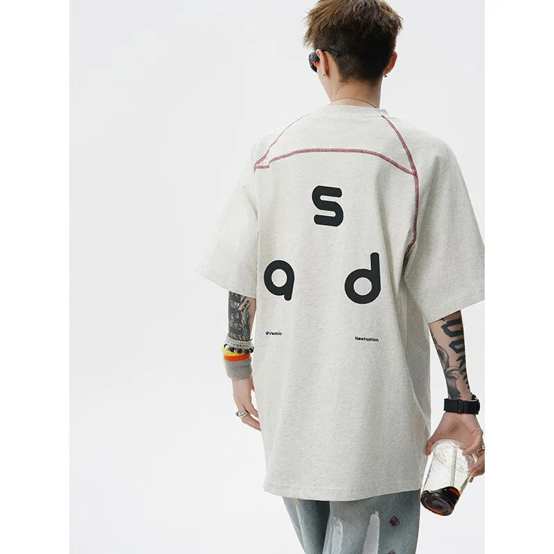 Black loose fit cotton T-shirt with short sleeves and a round neck collar featuring a letter print