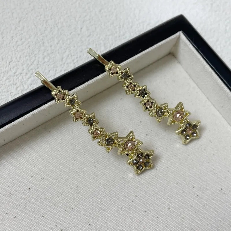 Korean style gold electroplated alloy hair barrette featuring a five-pointed star and word design.