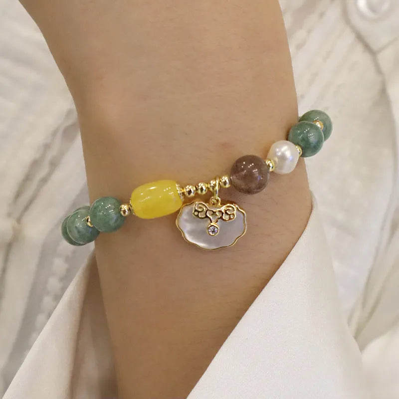 Natural green jade and shell bead bracelet with adjustable cord for women.