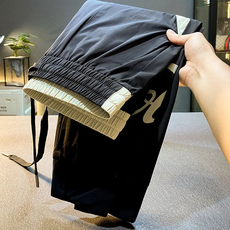 Black men's cropped casual trousers with ankle banding made from ultra-thin ice silk cotton fabric.