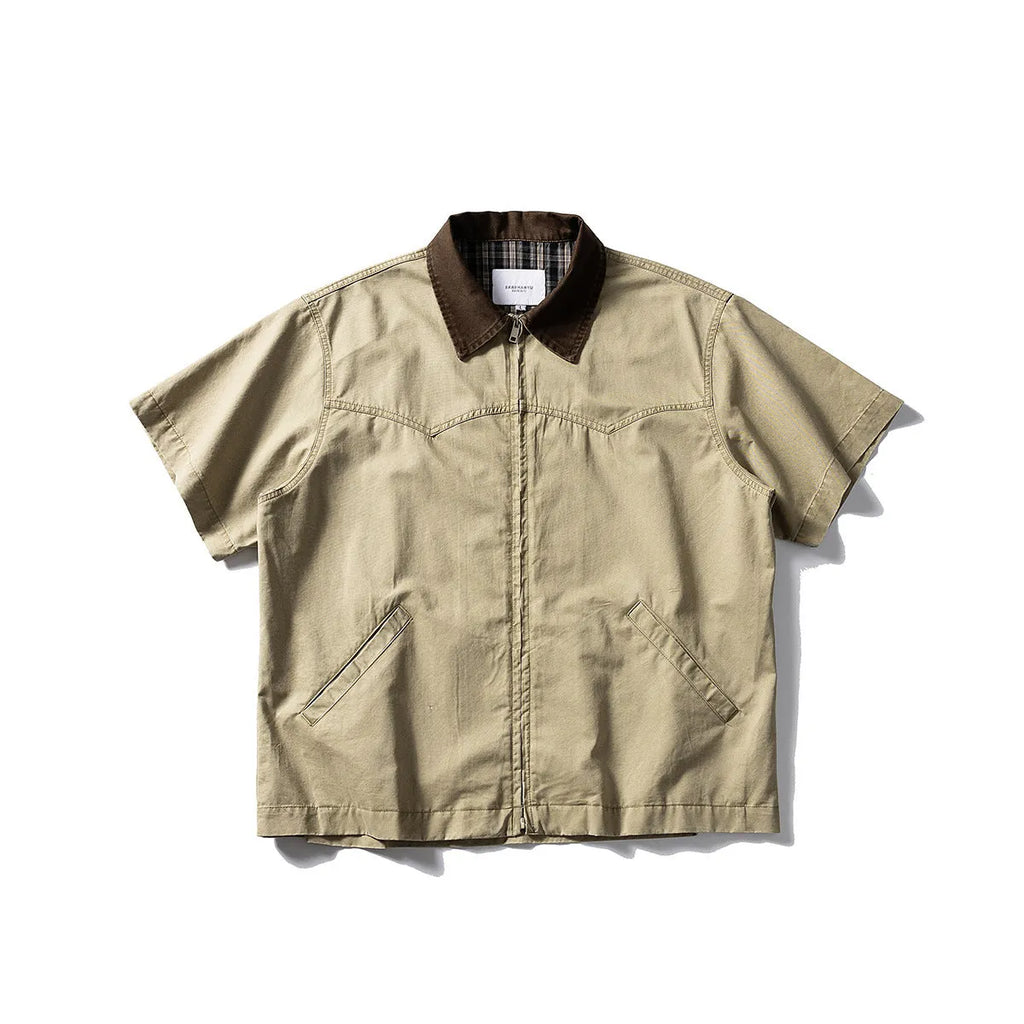 Teenager wearing a khaki loose-fit short sleeve cotton overalls shirt cardigan.