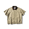 Teenager wearing a khaki loose-fit short sleeve cotton overalls shirt cardigan.