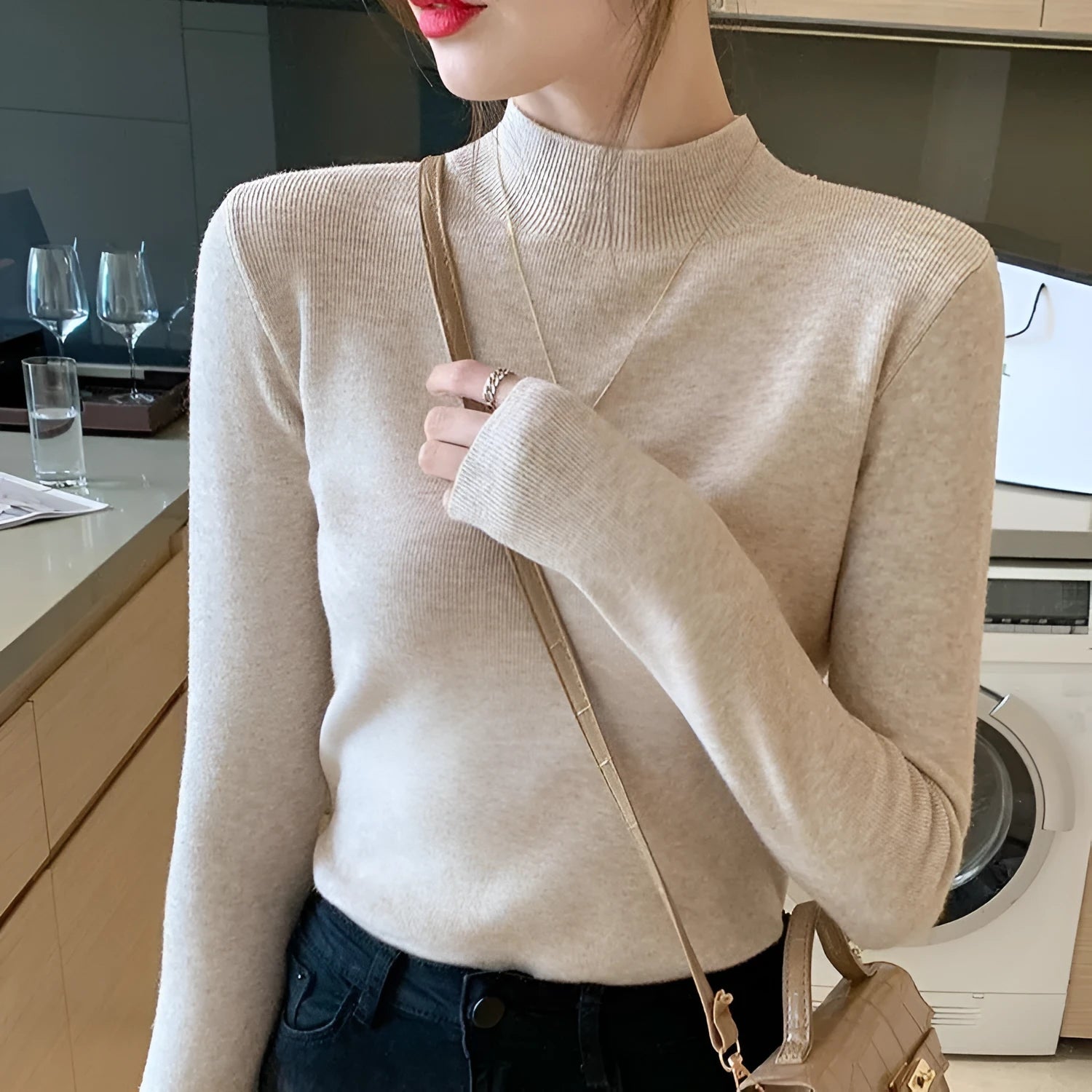 Women's slim fit long sleeve viscose knit top in a neutral colour on a hanger.